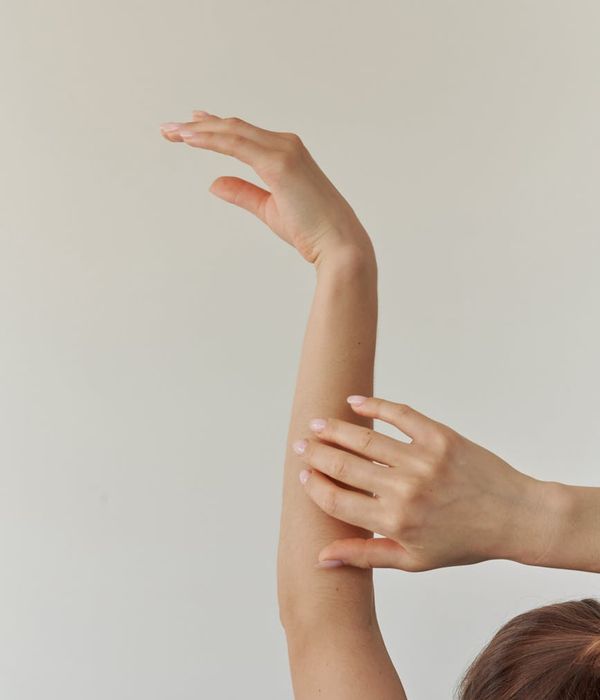 Woman in a graceful yoga pose with a lavender light accent.